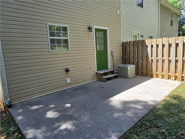 a view of a backyard with a small cabin and a chair
