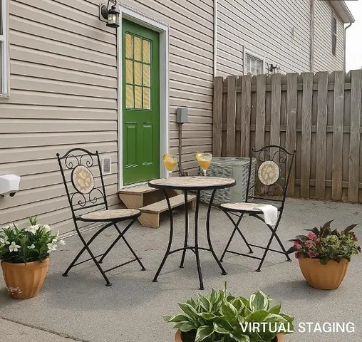 a view of a chairs and table in back of the house