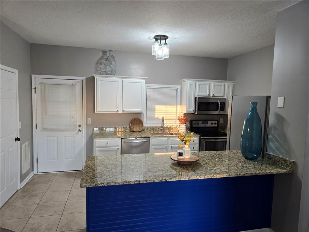 31 Corinth Road Cartersville, GA 30121 - Photo 6 of 35 a kitchen with granite countertop a sink cabinets and stainless steel appliances