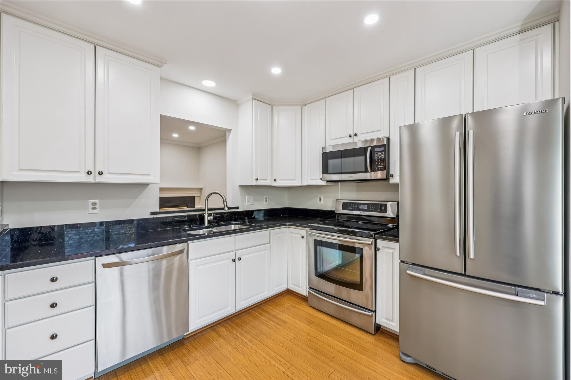 536 Tschiffely Square Road Gaithersburg, MD 20878 - Photo 56 of 116 a kitchen with granite countertop white cabinets stainless steel appliances and a refrigerator