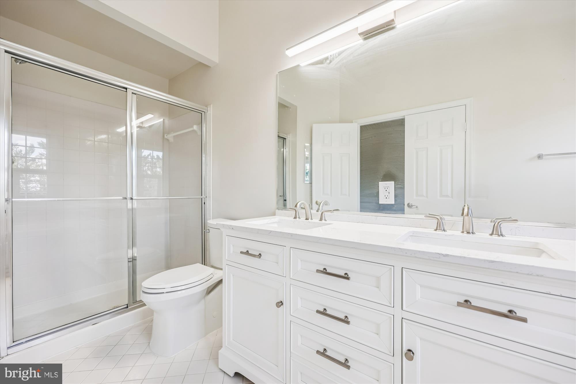 536 Tschiffely Square Road Gaithersburg, MD 20878 - Photo 67 of 116 a bathroom with a double vanity sink toilet mirror and shower
