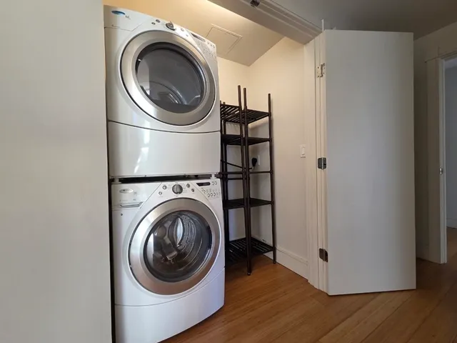 a view of a hallway with washer and dryer
