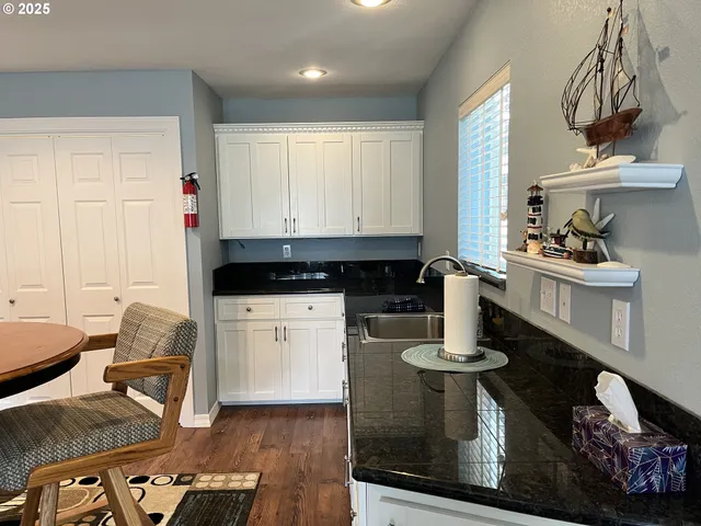a kitchen with sink and cabinets