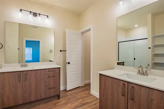 a spacious bathroom with a double vanity sink double and mirror