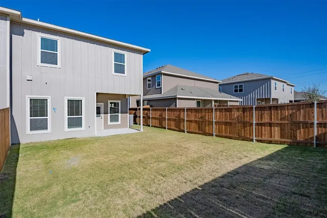 a view of a house with wooden fence