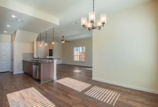 a kitchen with a refrigerator and a sink