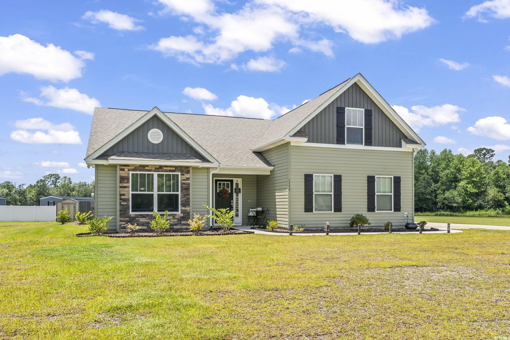 1170 Daisy Road Loris, SC 29569 - Photo 1 of 35 Craftsman house with board and batten siding, a shingled roof, and stone siding