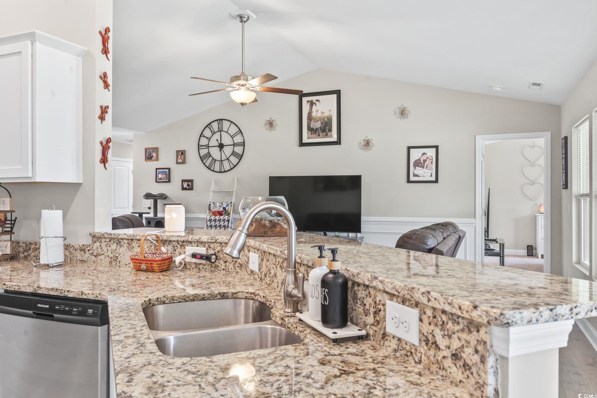 1170 Daisy Road Loris, SC 29569 - Photo 15 of 35 Kitchen with stainless steel dishwasher, ceiling fan, vaulted ceiling, light stone countertops, and white cabinetry