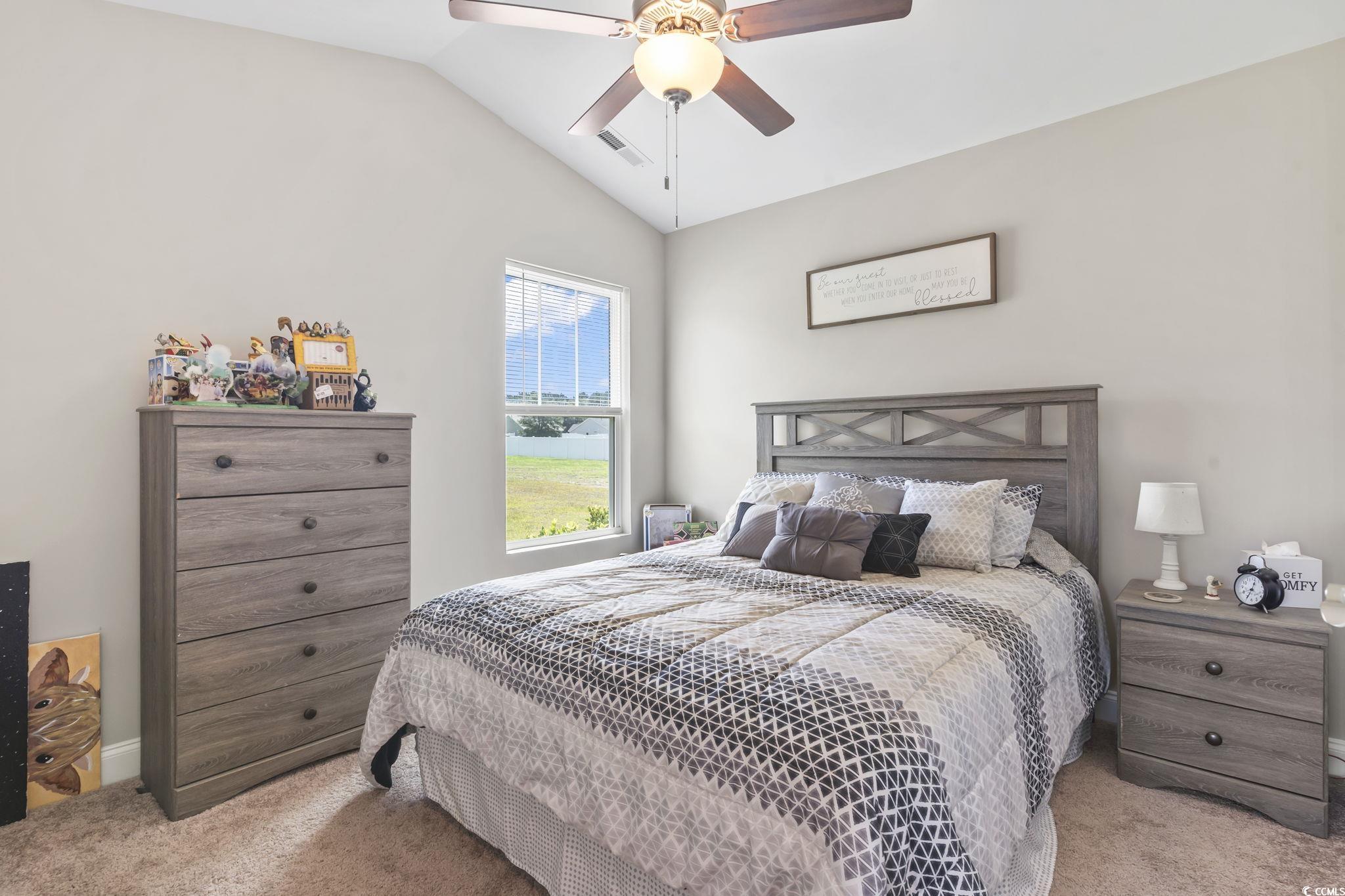 1170 Daisy Road Loris, SC 29569 - Photo 21 of 35 Carpeted bedroom with vaulted ceiling and a ceiling fan
