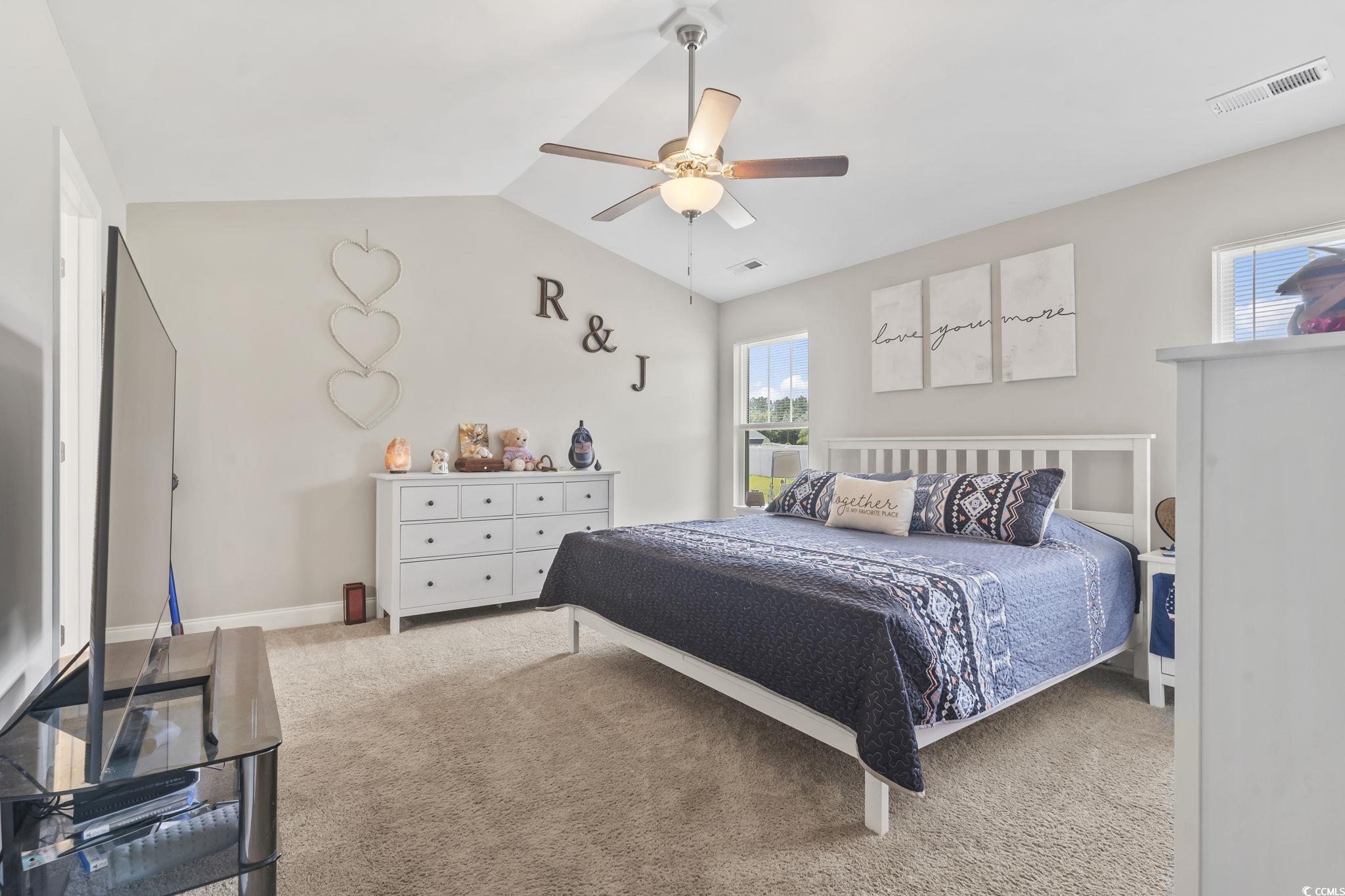 1170 Daisy Road Loris, SC 29569 - Photo 22 of 35 Carpeted bedroom with vaulted ceiling and a ceiling fan