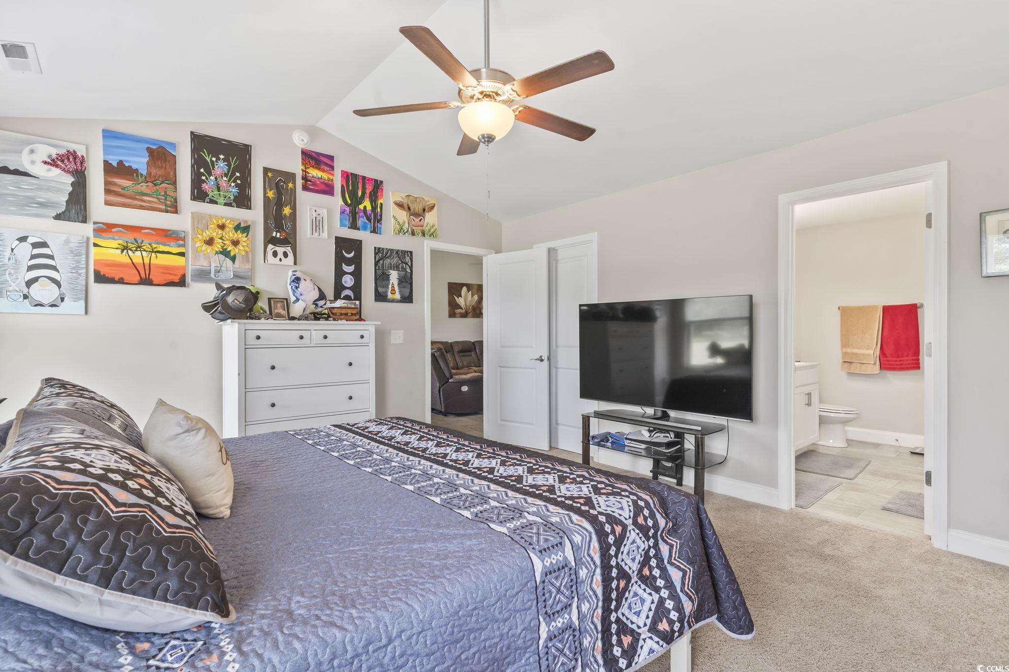 1170 Daisy Road Loris, SC 29569 - Photo 23 of 35 Bedroom with vaulted ceiling, carpet flooring, connected bathroom, and ceiling fan
