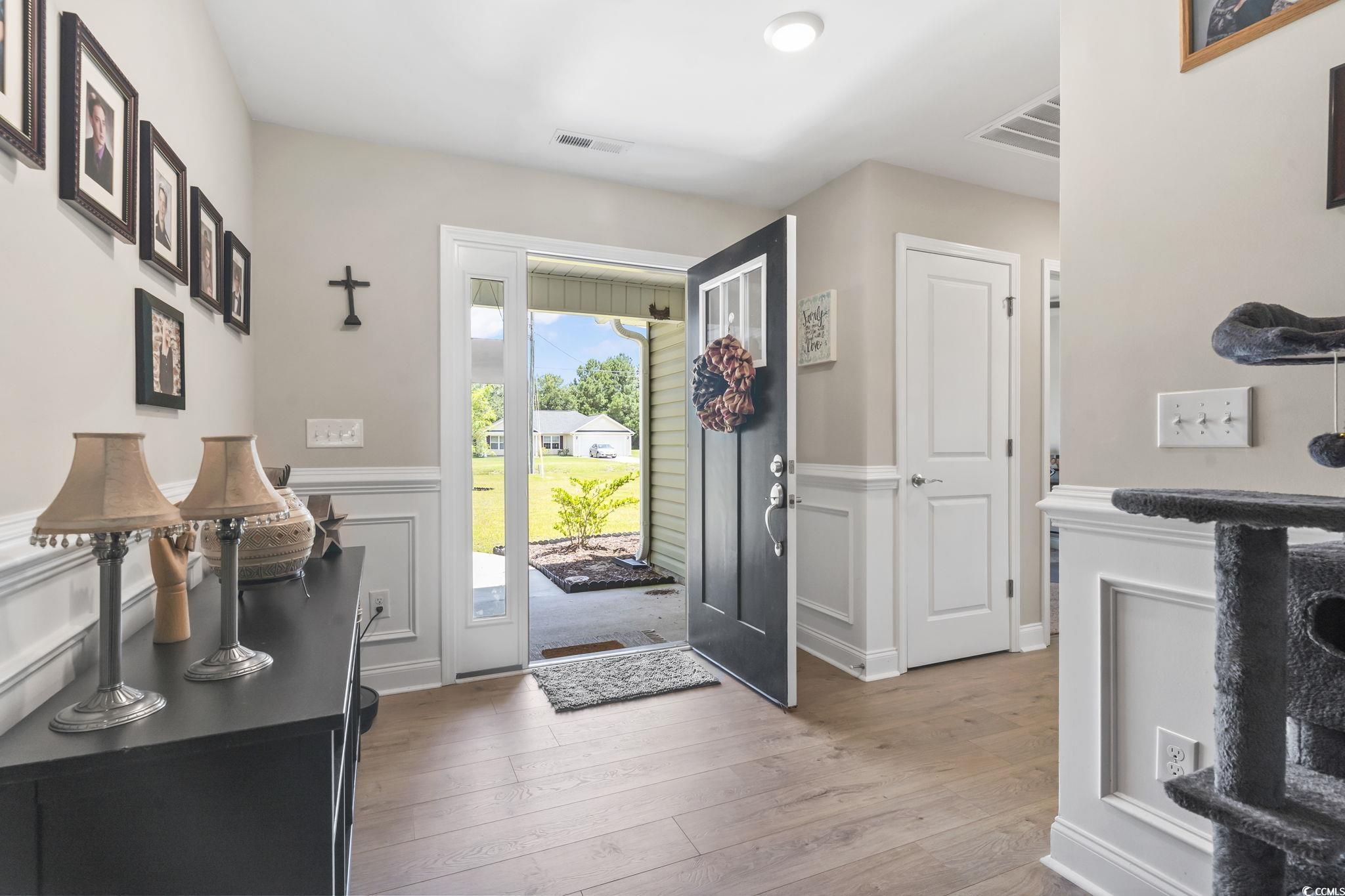 1170 Daisy Road Loris, SC 29569 - Photo 4 of 35 Foyer with light wood-style floors and wainscoting