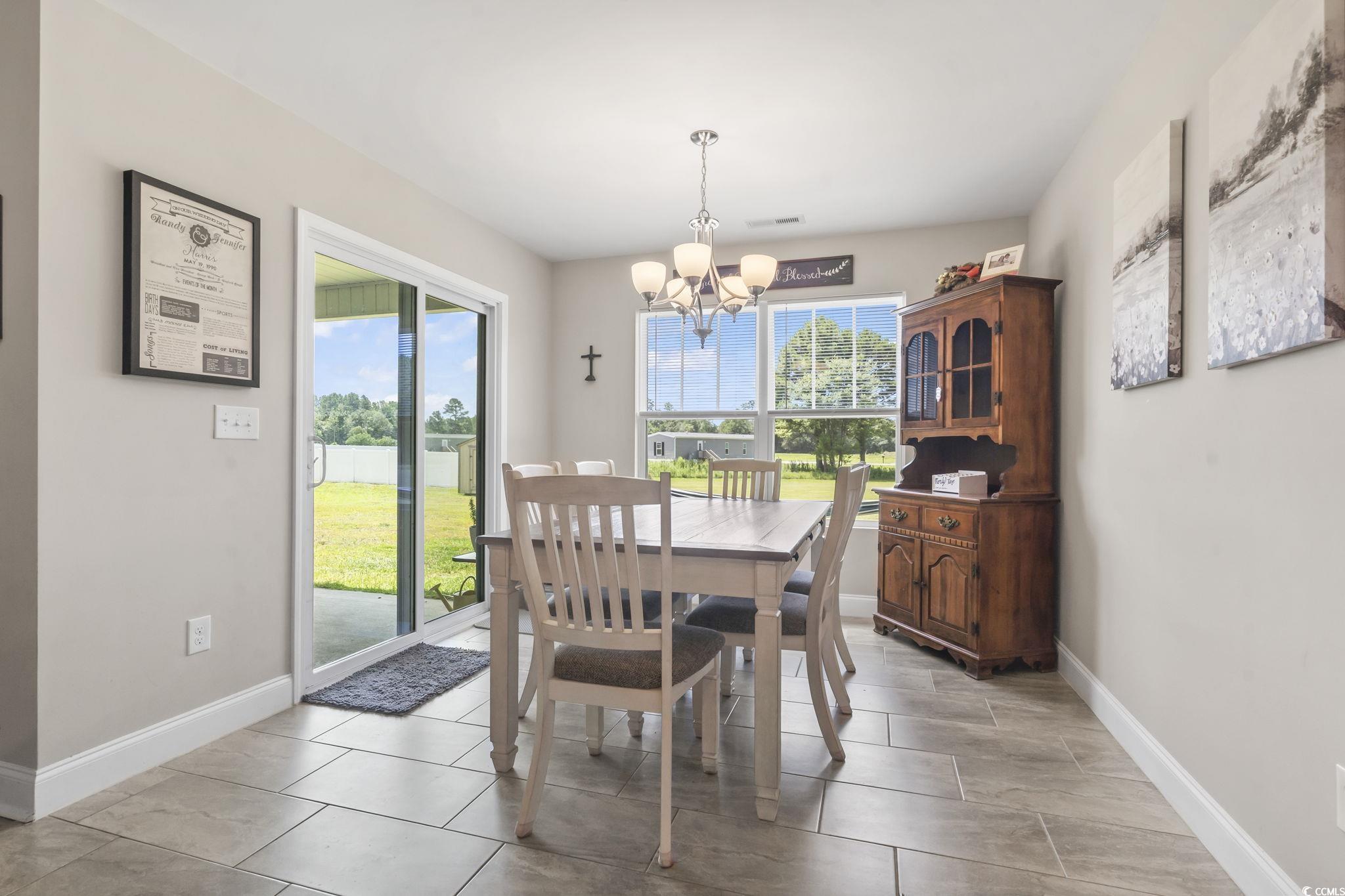 1170 Daisy Road Loris, SC 29569 - Photo 9 of 35 Dining space with a chandelier and baseboards