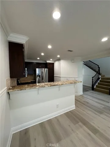 a view of kitchen with kitchen island microwave and stove refrigerator