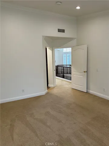 an empty room with windows and cabinet