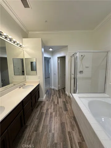 a large bathroom with a double vanity sink and mirror with shower