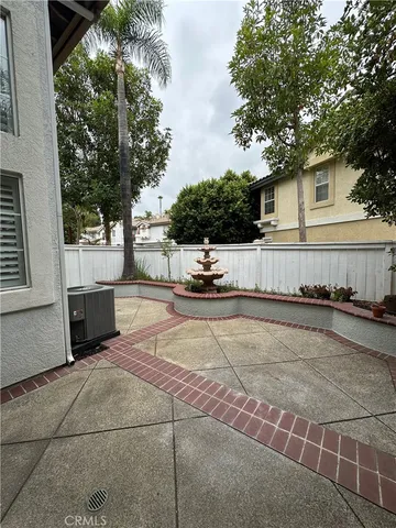 a view of a white house with a large tree