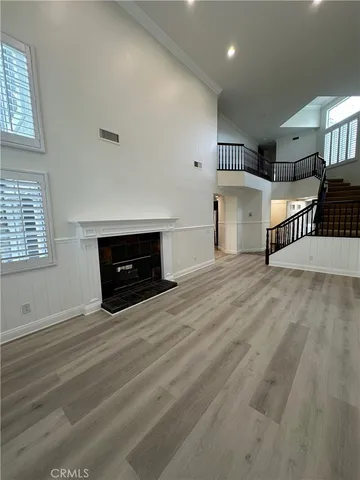 a view of empty room with a fireplace and windows