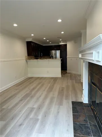 a view of kitchen with cabinets and fireplace