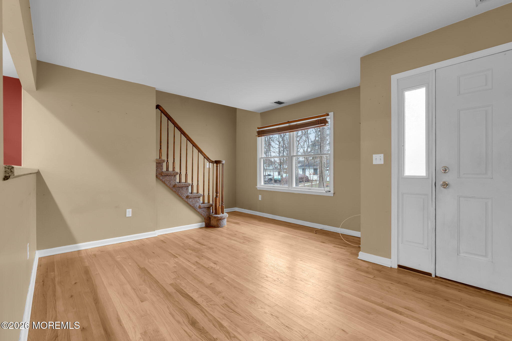 9 Forecastle Way Waretown, NJ 08758 - Photo 7 of 51 a view of an empty room with wooden floor and a window