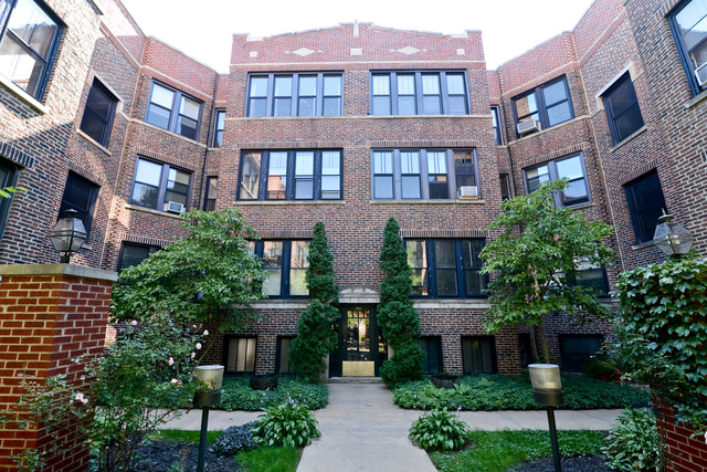 751 West Brompton Avenue, Unit 2E Chicago, IL 60657 - Photo 1 of 10 a front view of a building with a garden and plants