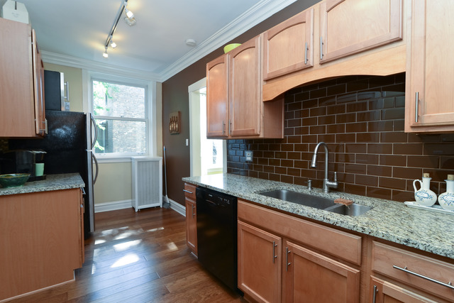 751 West Brompton Avenue, Unit 2E Chicago, IL 60657 - Photo 6 of 10 a kitchen with granite countertop a sink a counter space and cabinets