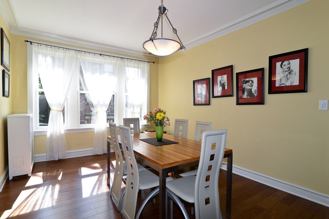 751 West Brompton Avenue, Unit 2E Chicago, IL 60657 - Photo 7 of 10 a view of a dining room with furniture window and wooden floor