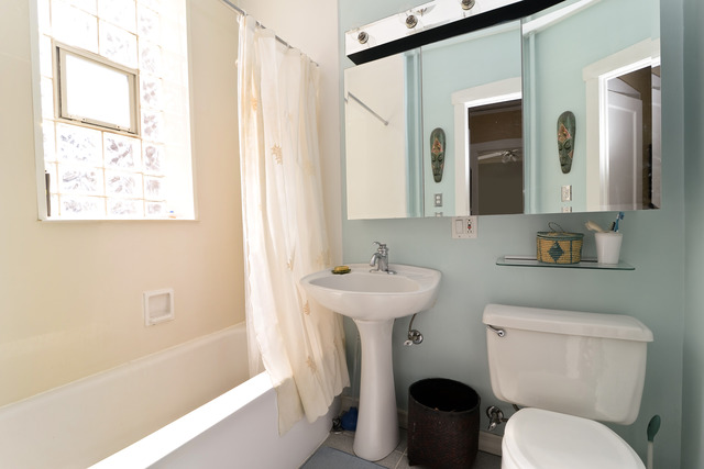751 West Brompton Avenue, Unit 2E Chicago, IL 60657 - Photo 9 of 10 a bathroom with a toilet sink and mirror