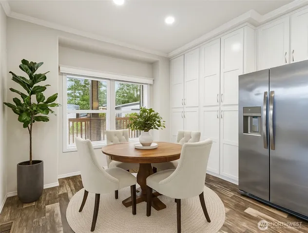 a dining room with furniture potted plants and wooden floor