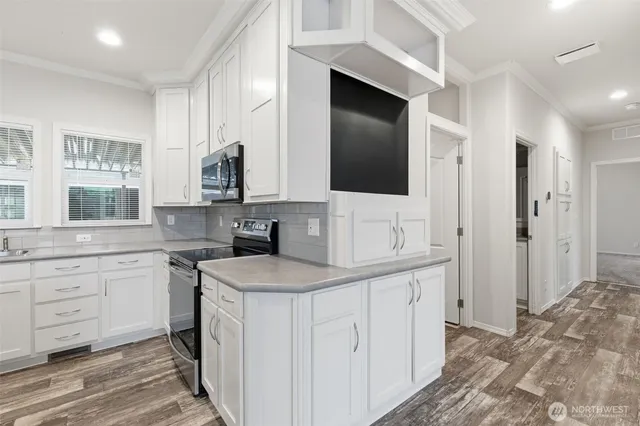 a kitchen with a sink stove and microwave