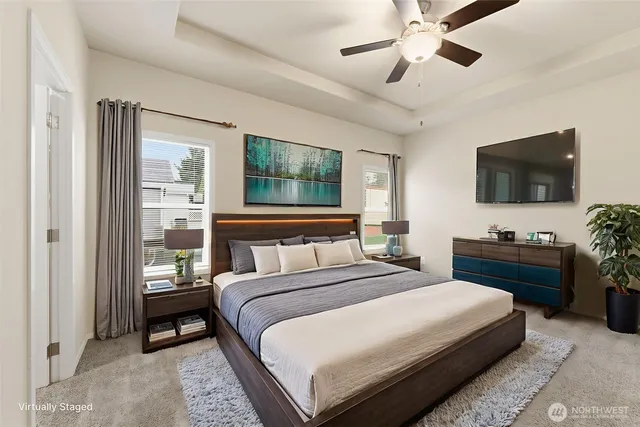 a bedroom with a bed a tv and wooden floor