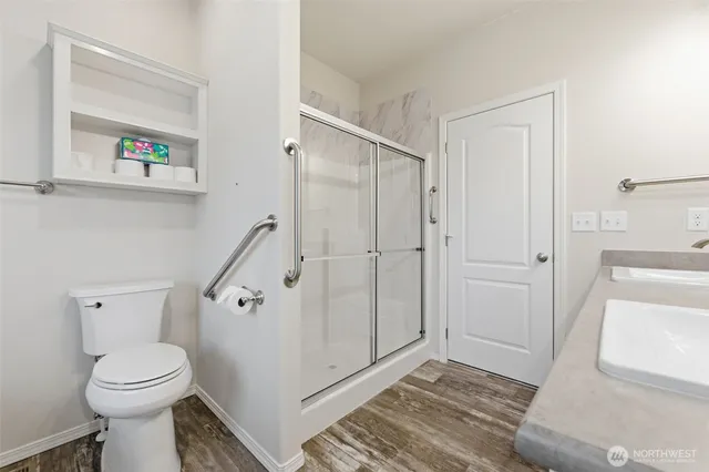 a bathroom with a toilet and a shower