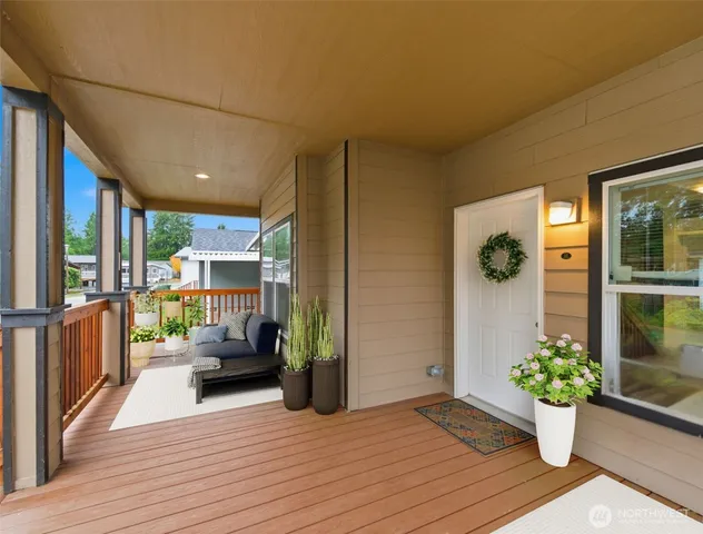 a living room with furniture and potted plants