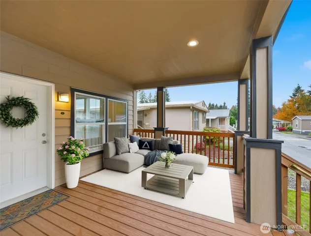 a balcony with furniture and wooden floor