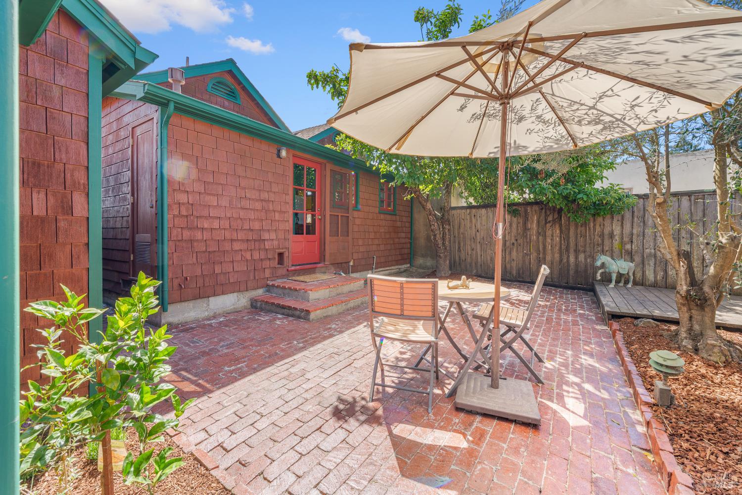 309 Hendley Street Santa Rosa, CA 95404 - Photo 10 of 31 a patio with a table and chairs under an umbrella
