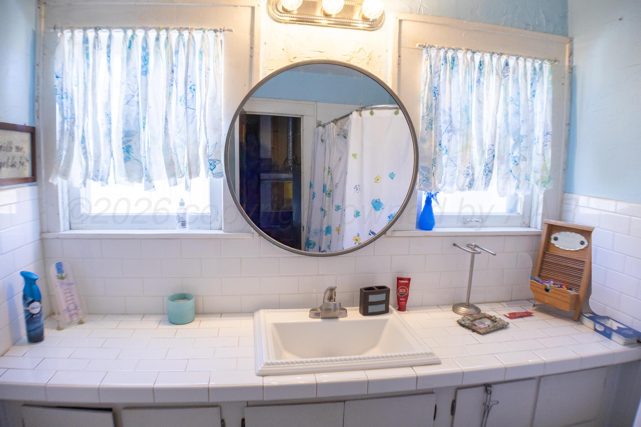 801 North Main Street McLean, TX 79057 - Photo 24 of 24 a bathroom with a sink and a mirror