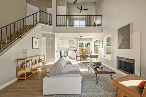 a living room with furniture a rug and a fireplace