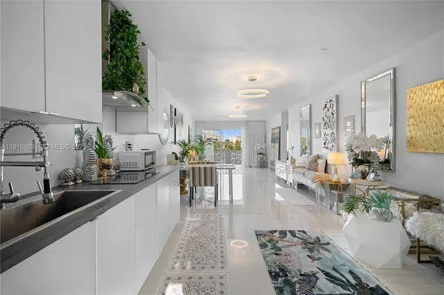 a very nice looking living room with a large window and potted plants