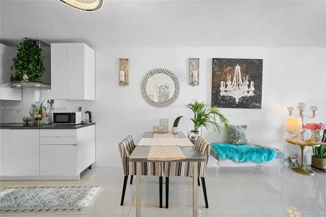 a kitchen with stainless steel appliances a white cabinets and a potted plant
