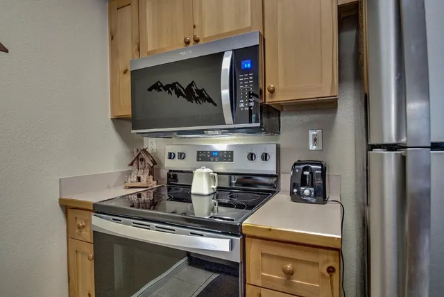 a stove top oven sitting inside of a kitchen