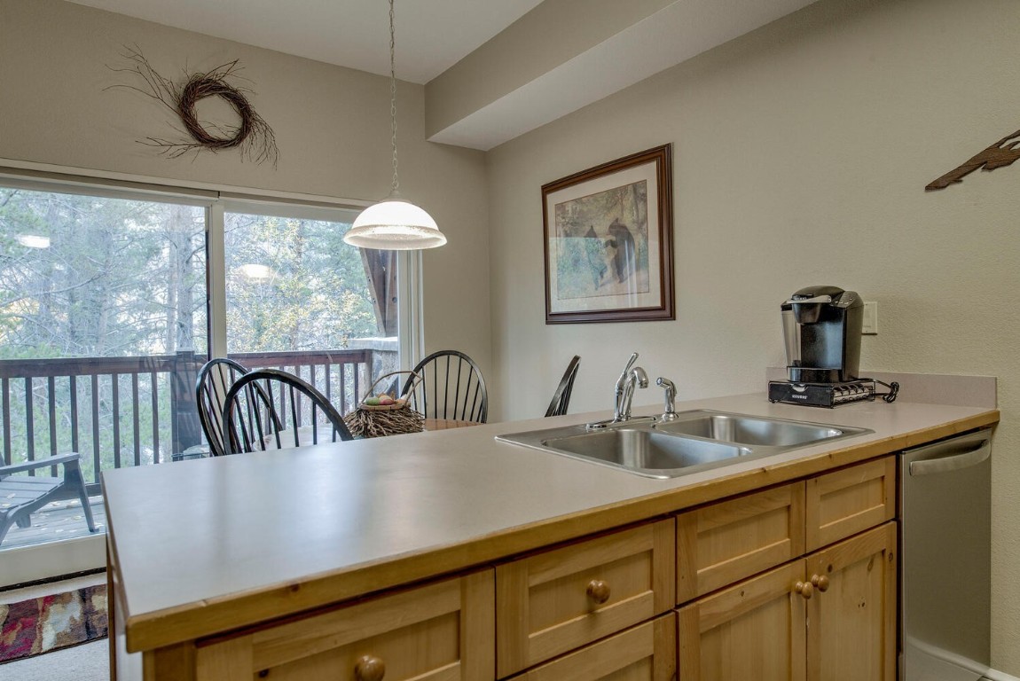 97 Lake Ridge Circle, Unit 1854 Keystone, CO 80435 - Photo 12 of 38 a view of kitchen and sink with wooden floor