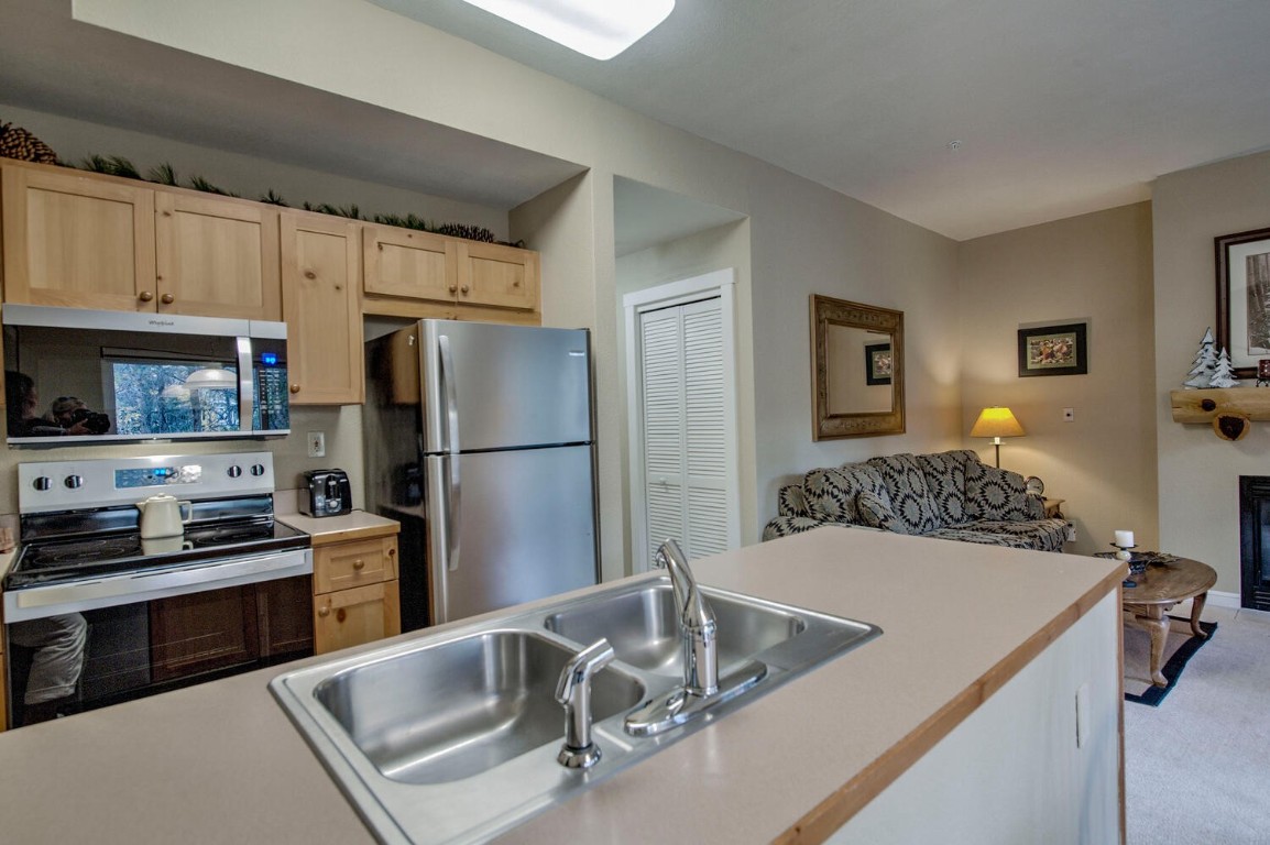 97 Lake Ridge Circle, Unit 1854 Keystone, CO 80435 - Photo 13 of 38 a kitchen with stainless steel appliances granite countertop a sink stove and refrigerator