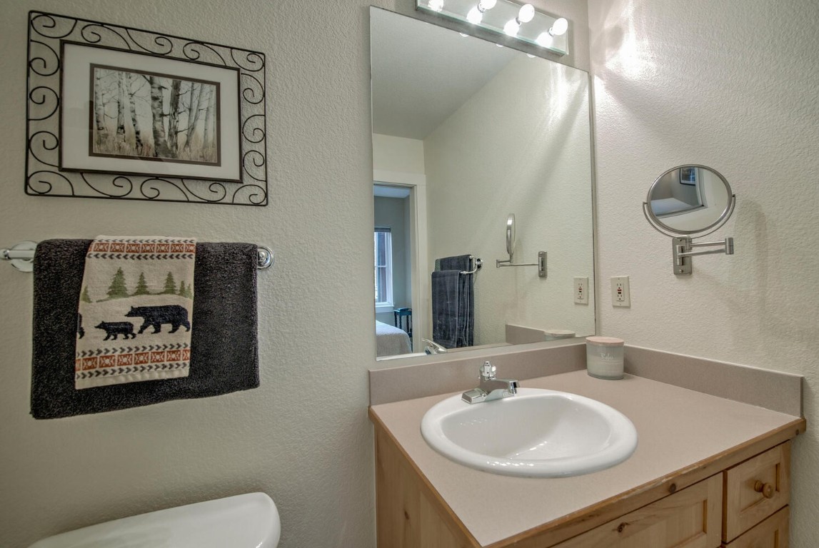 97 Lake Ridge Circle, Unit 1854 Keystone, CO 80435 - Photo 18 of 38 a bathroom with a toilet a sink and mirror