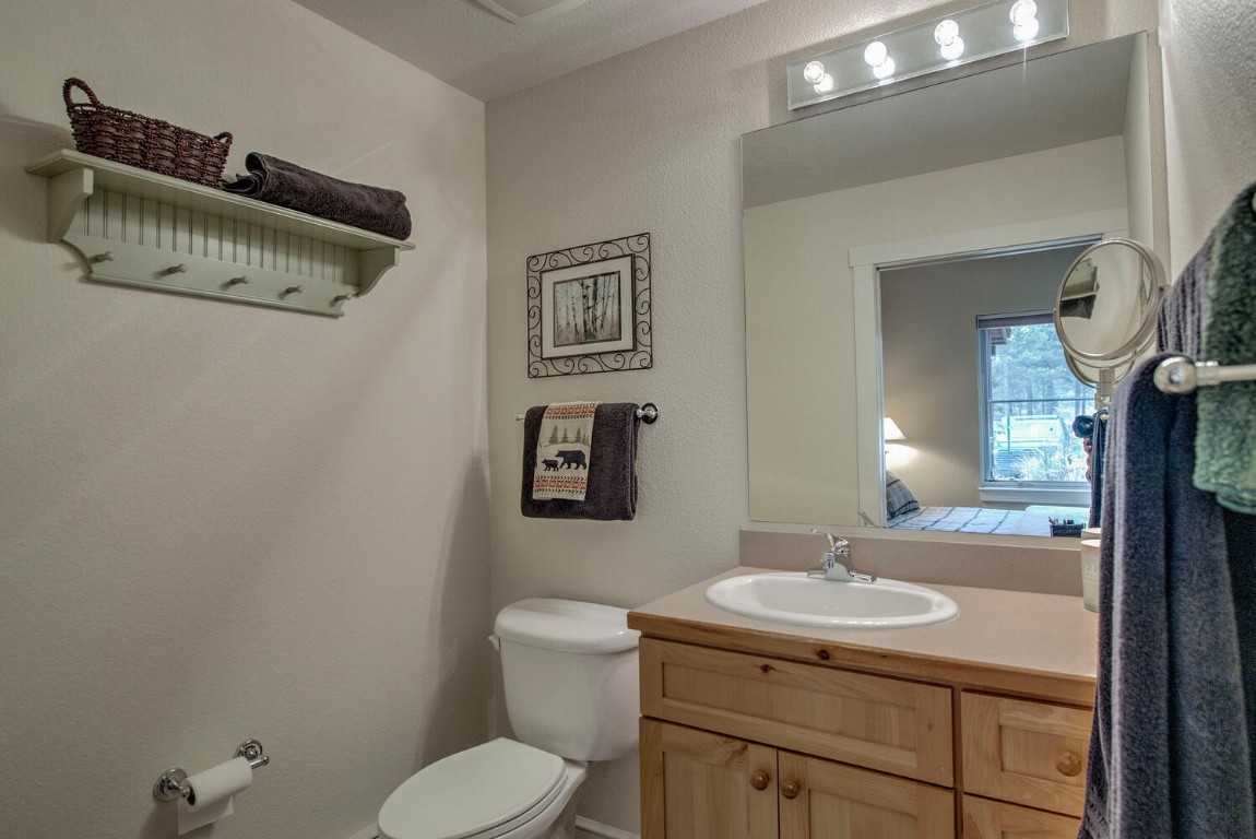 97 Lake Ridge Circle, Unit 1854 Keystone, CO 80435 - Photo 19 of 38 a bathroom with a sink a toilet and mirror