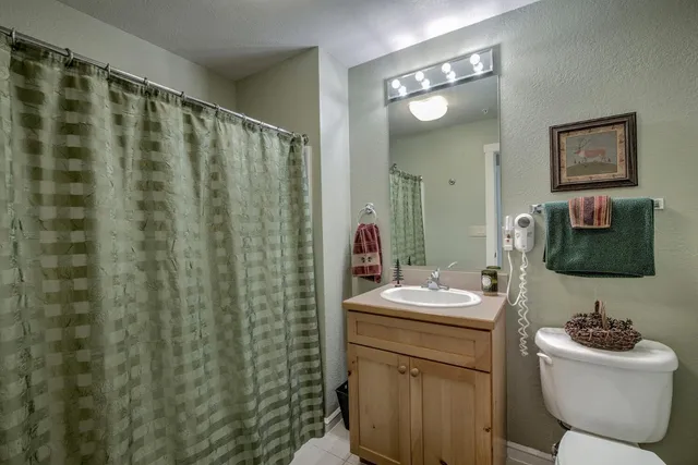 a bathroom with a sink toilet and mirror