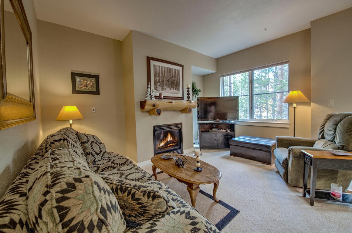 97 Lake Ridge Circle, Unit 1854 Keystone, CO 80435 - Photo 5 of 38 a living room with furniture and a fireplace