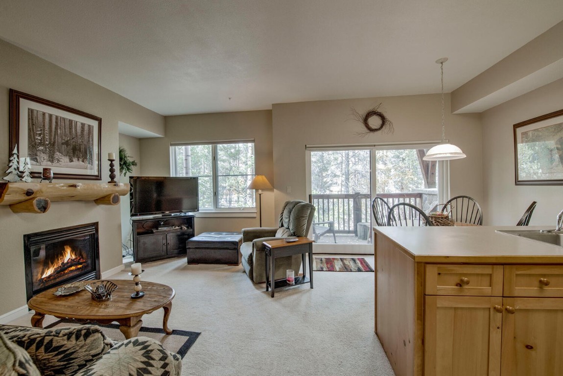 97 Lake Ridge Circle, Unit 1854 Keystone, CO 80435 - Photo 8 of 38 a living room with furniture a flat screen tv and a fireplace