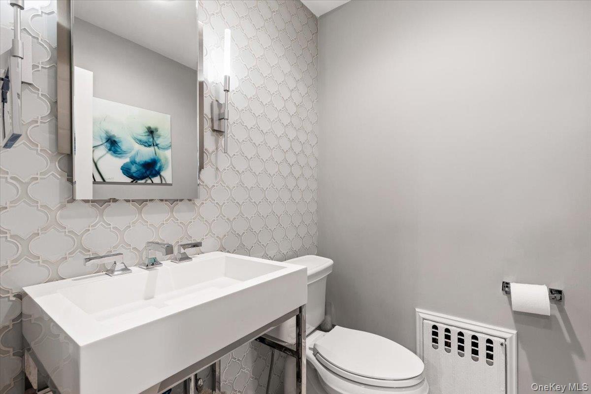 6 Valley Place Harrison, NY 10528 - Photo 14 of 37 a bathroom with a sink a toilet and mirror