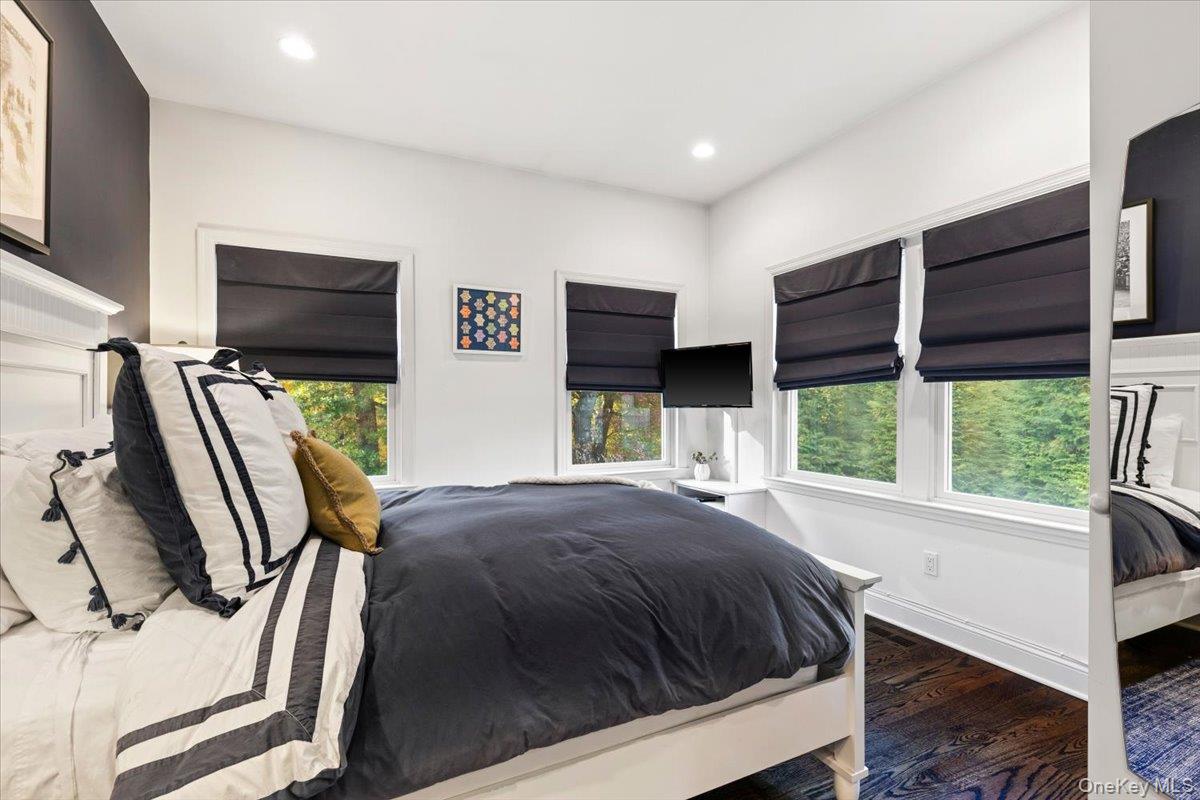 6 Valley Place Harrison, NY 10528 - Photo 15 of 37 a bedroom with a bed tv and a large window
