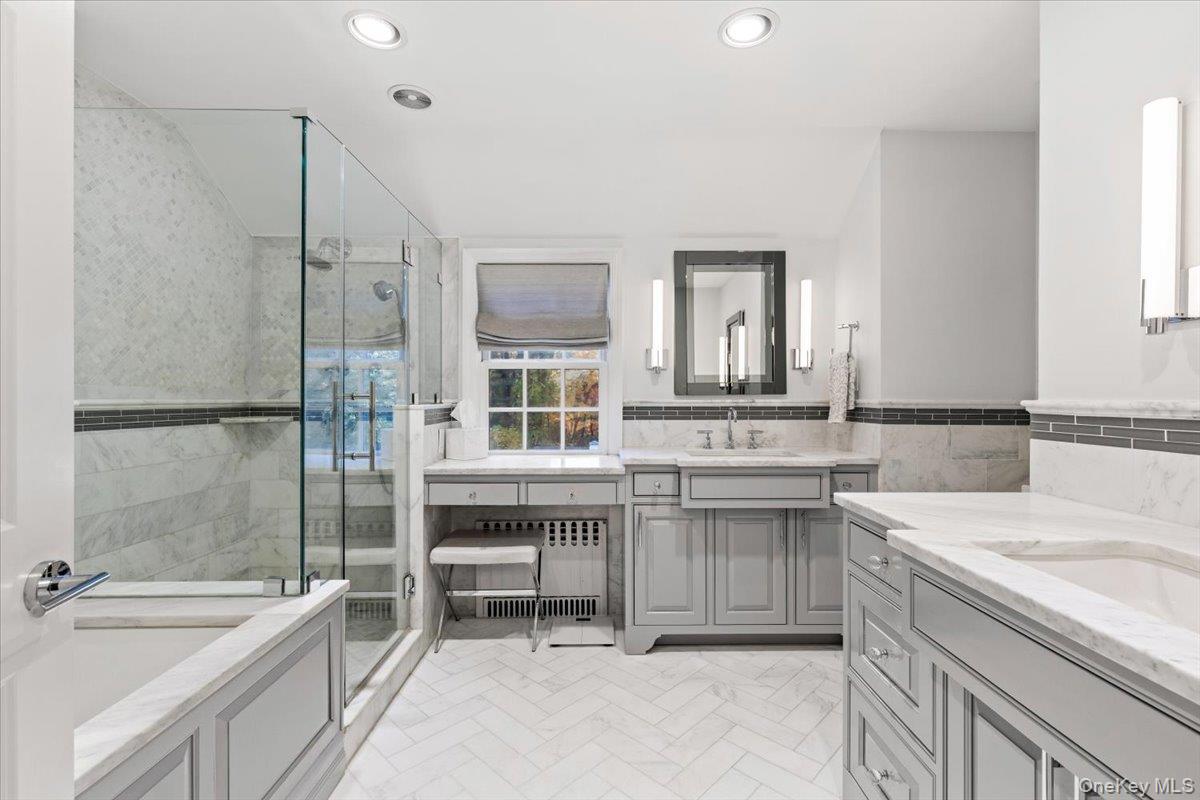 6 Valley Place Harrison, NY 10528 - Photo 20 of 37 a bathroom with a granite countertop sink and a bathtub